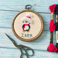 Load image into Gallery viewer, Small hand embroidered Christmas ornament with a child's name and penguin design, made in Dubai