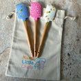 Load image into Gallery viewer, Three wooden spatulas with colorful handles on a 'Mumz Little Chefs' bag.