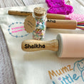 Load image into Gallery viewer, Wooden stamp with 'Shaikha' engraved, surrounded by baking items on a table.