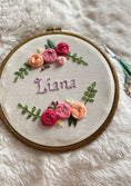 Load image into Gallery viewer, Embroidery hoop with floral design and embroidered name 'Liana' on a soft white background