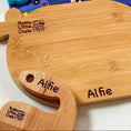 Load image into Gallery viewer, Children's kitchen set with cutting board, utensils, and apron on a blue fabric background.