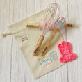 Load image into Gallery viewer, Baking tools with personalized names on a drawstring bag labeled 'Mumz Little Chetz' on a wooden surface.