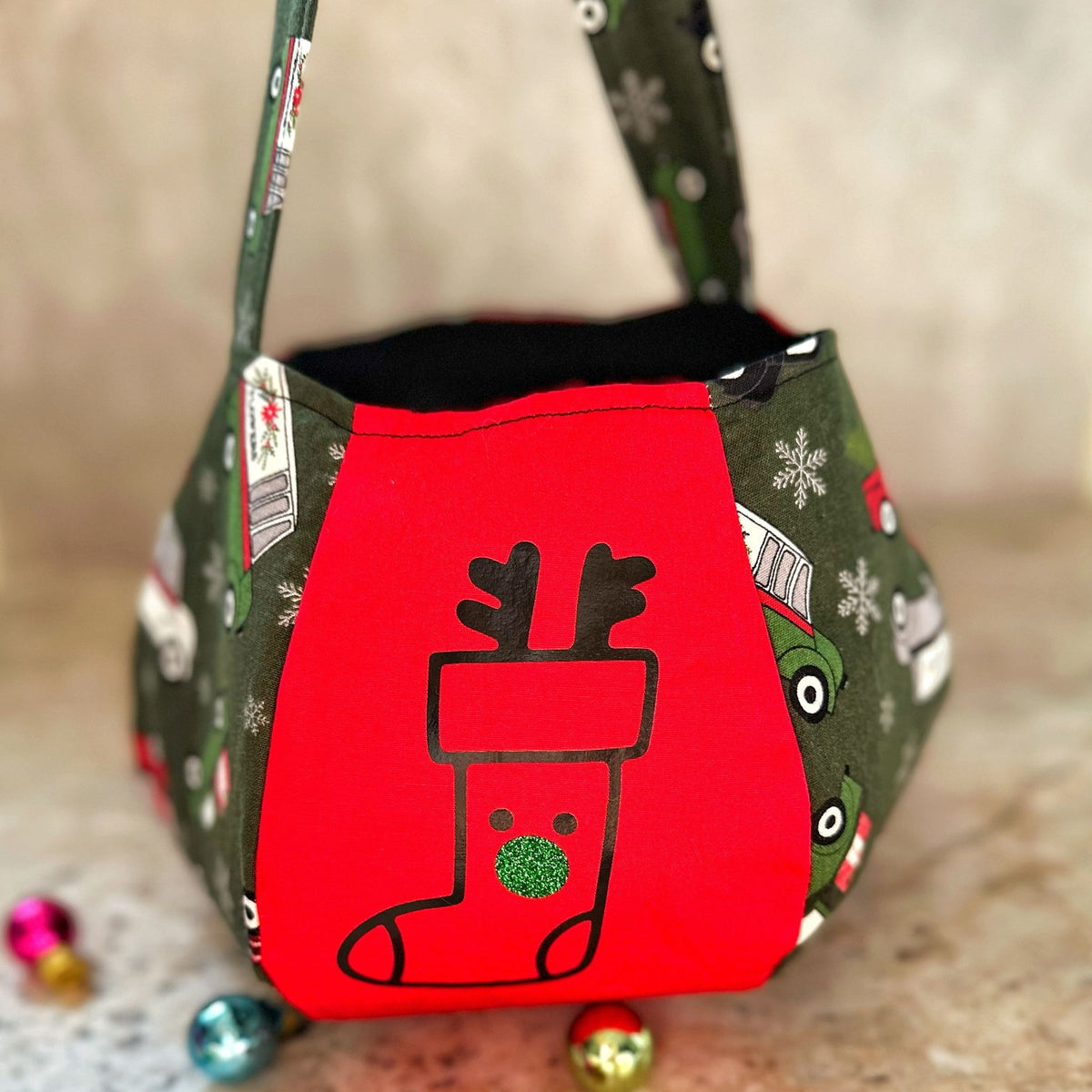 Personalised Christmas treat pouch filled with treats by the tree