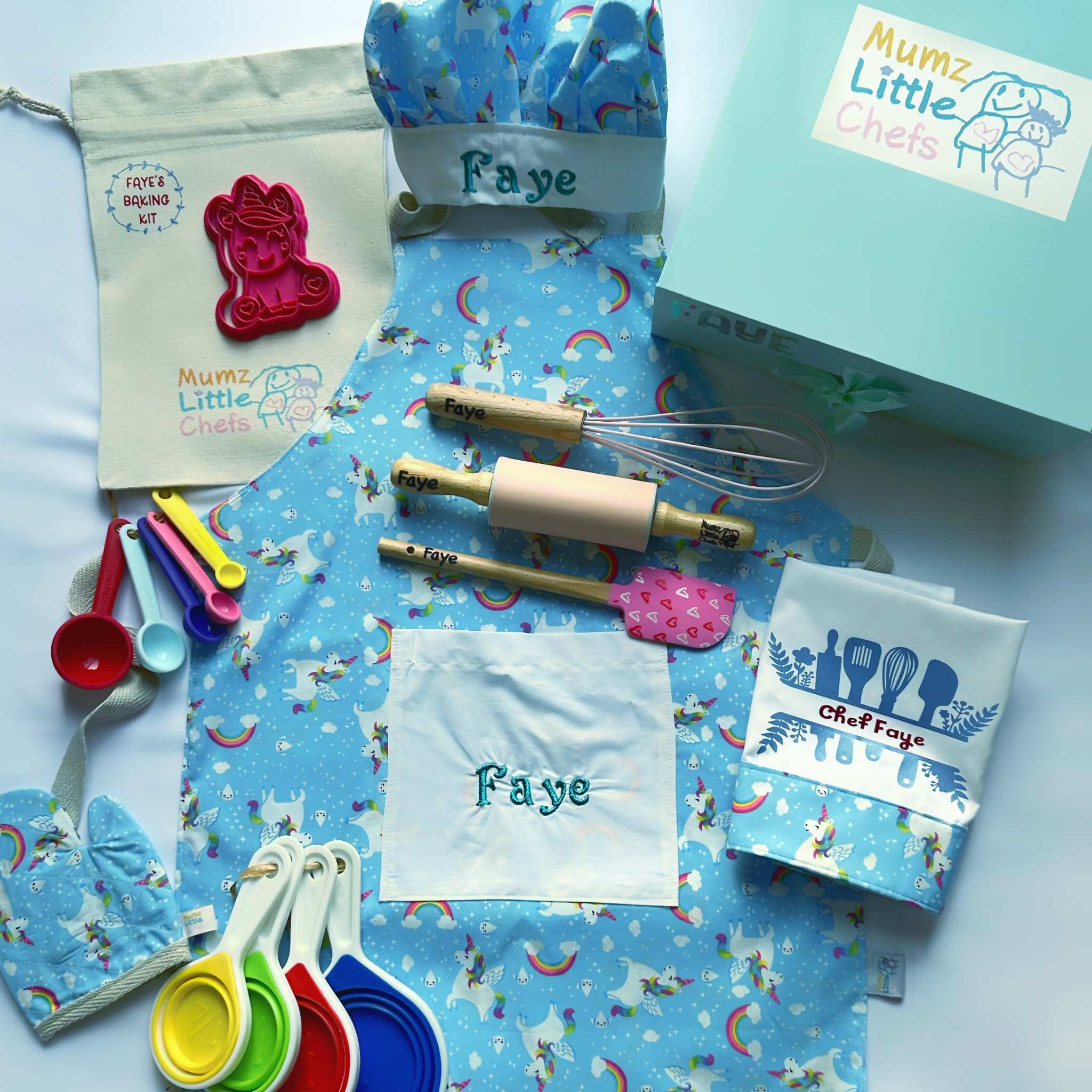 a personalised baking kit for kids including personalised apron, chef hat and matching glove with personalised spatula rolling pin and whisk