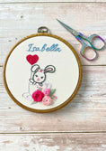 Load image into Gallery viewer, Embroidery hoop with a bunny and flowers design, scissors on a wooden surface
