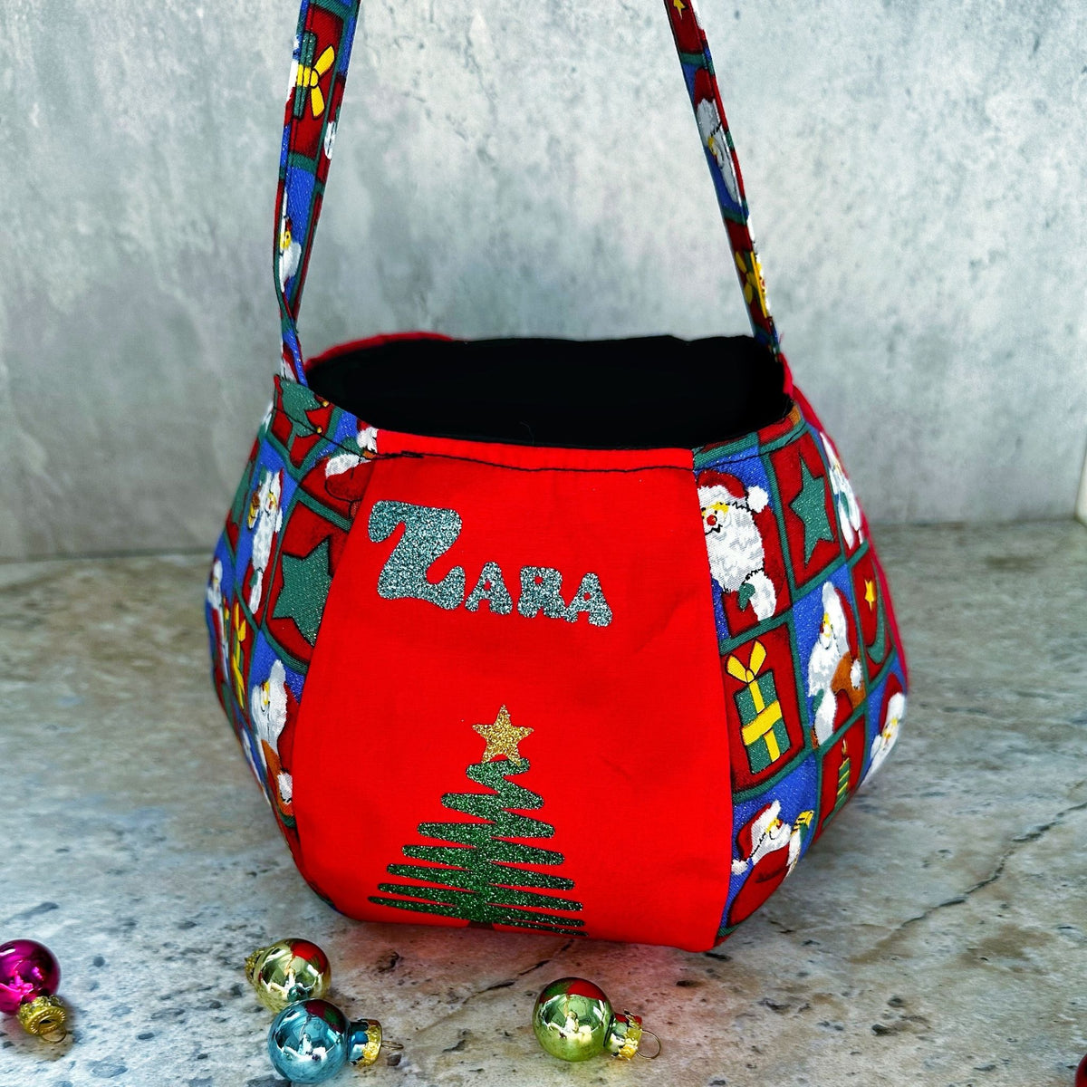 Personalised Santa treat pouch with a child's name in festive fabric, made in Dubai