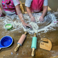 Load image into Gallery viewer, Children playing with flour on a wooden table with personalized kitchen tools.
