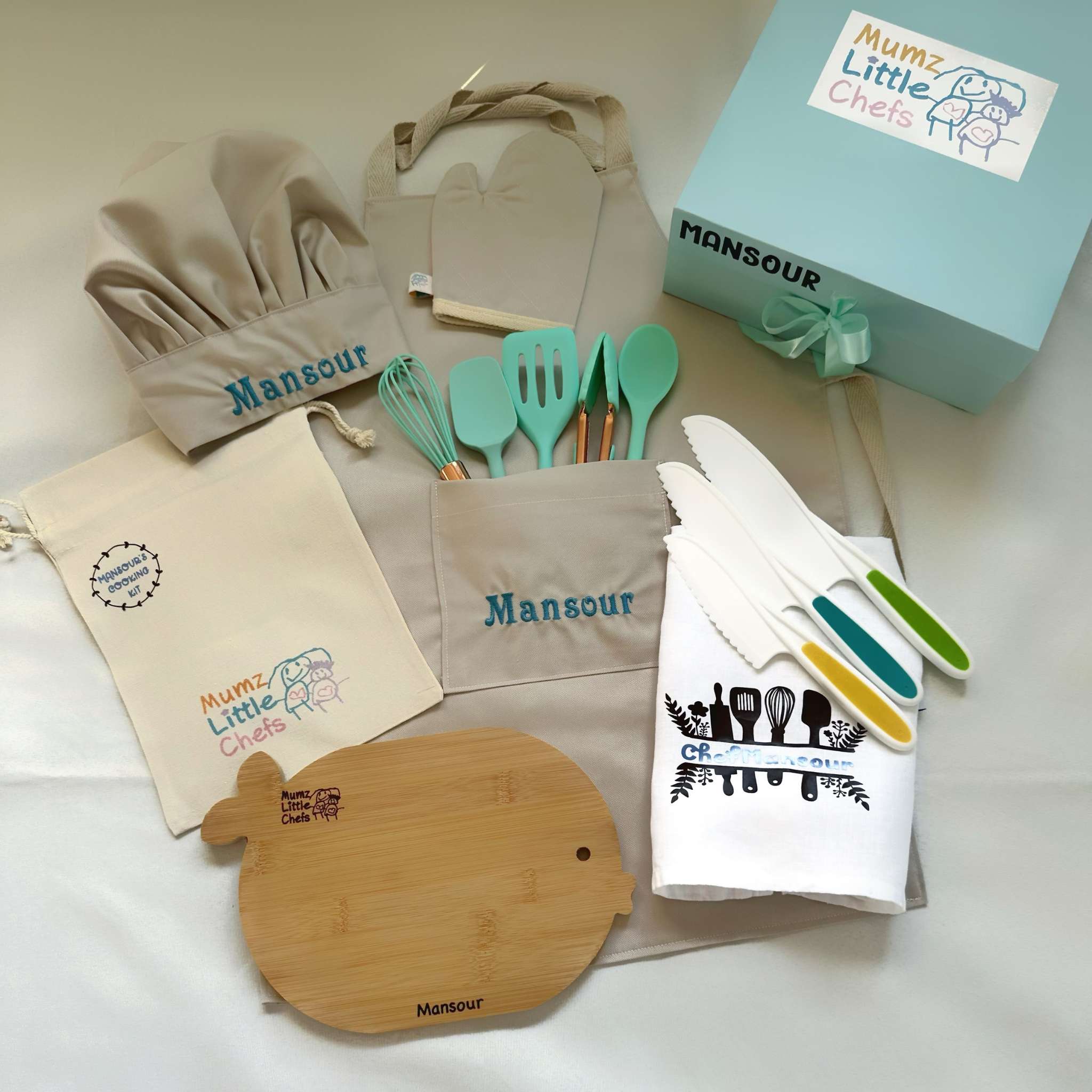 Collection of kitchen utensils and accessories with 'Mansour' branding on a light background
